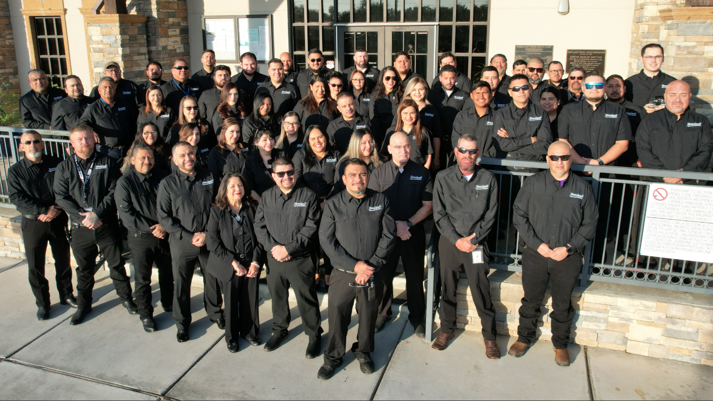 Group photo of Sharyland Water Supply Corporation staff in front of their office building
