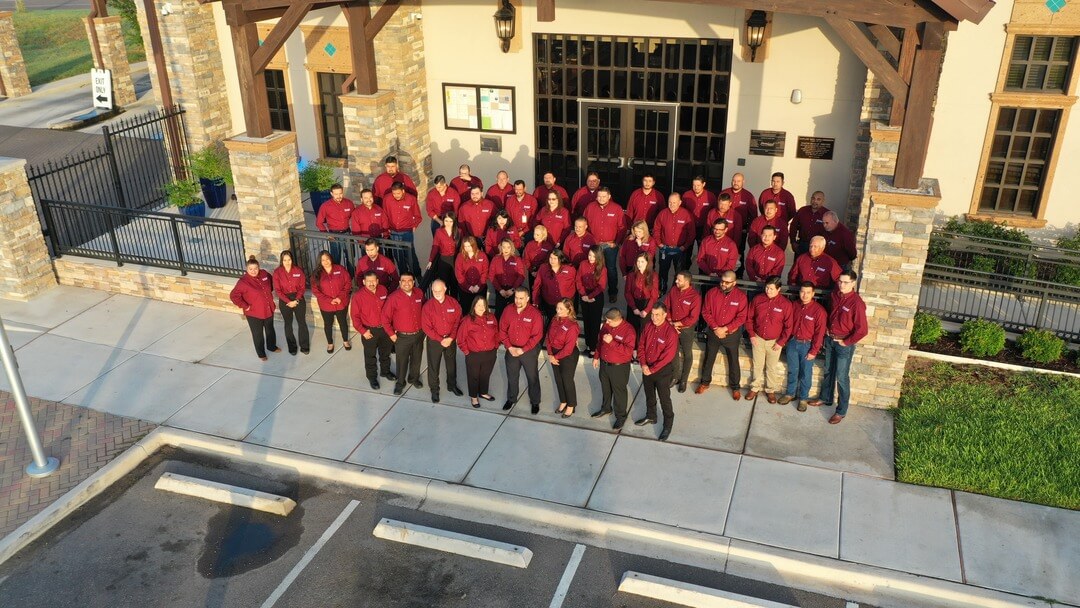 Group photo of Sharyland Water Supply Corporation staff in front of their office building